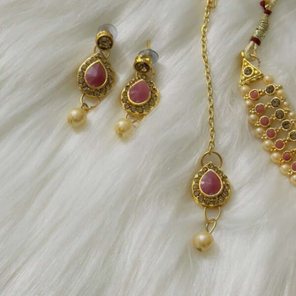 purple earrings and tikka