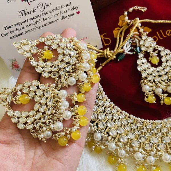 yellow earrings with tikka
